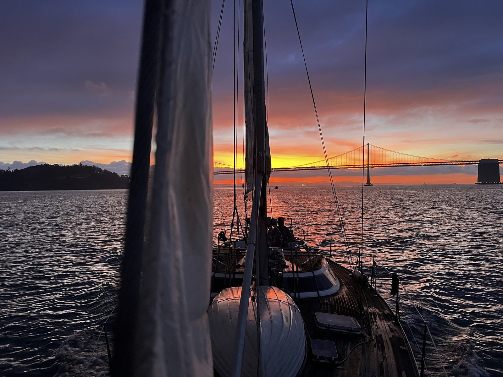 The mast in silhouette against a burning sunset