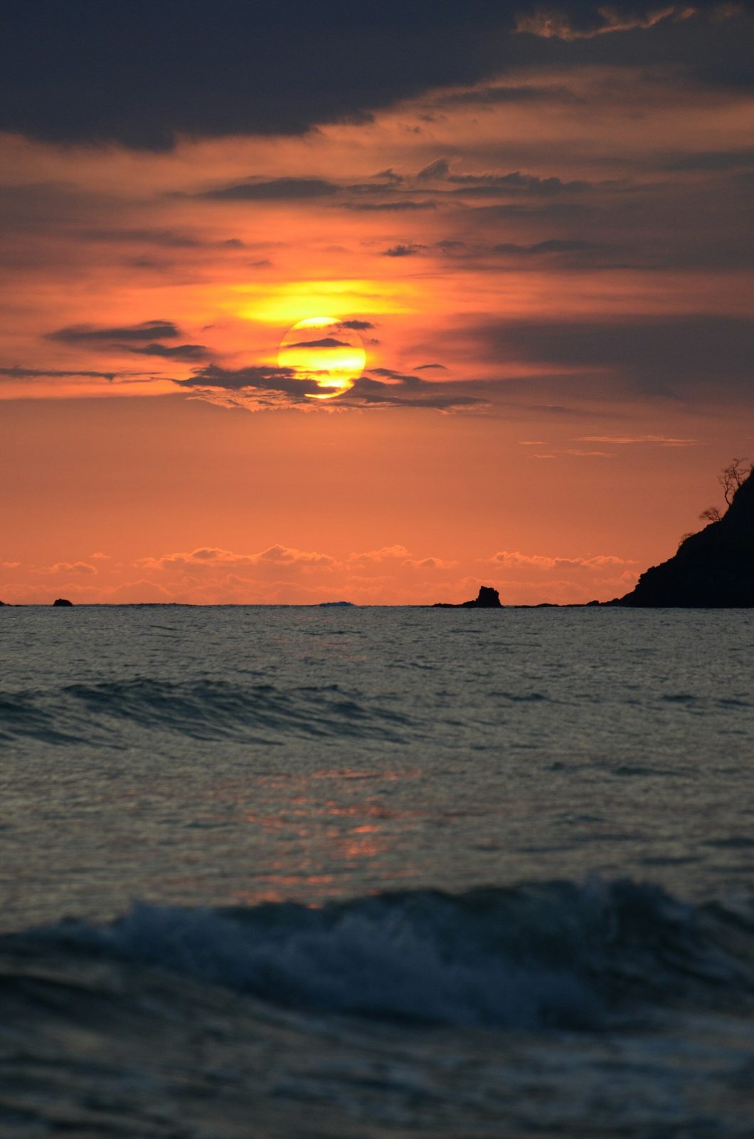 A burnt-orange sunset over the open sea